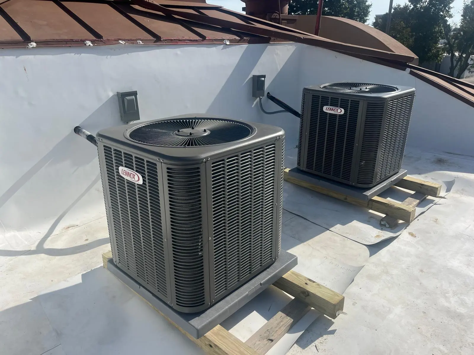 Dual Lennox commercial rooftop condenser unit installation